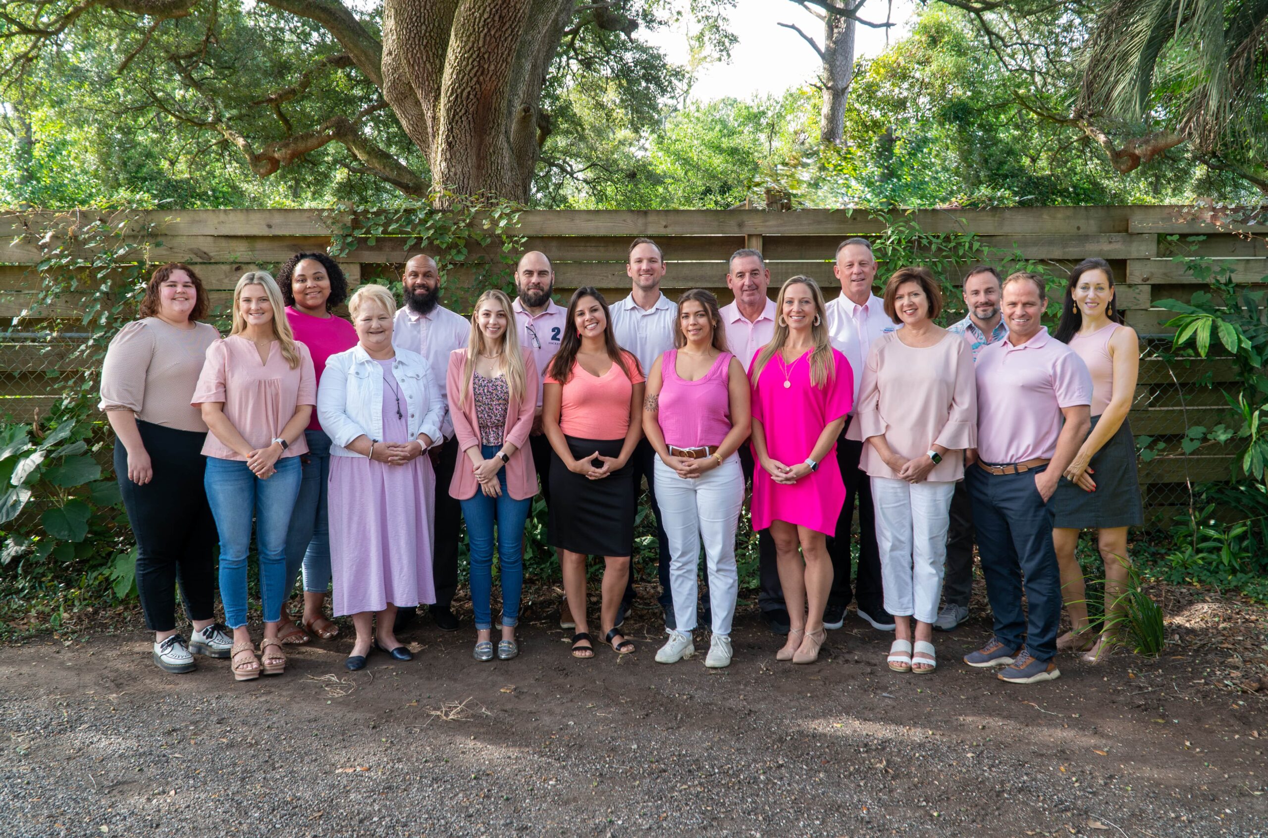 Joe Manausa Company in Pink for Breast Cancer Awareness in front of the Joe Manausa office
